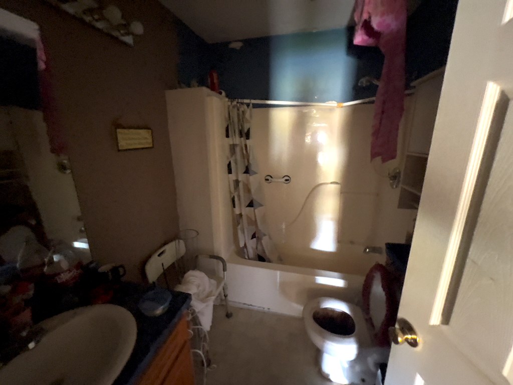 927 Vineville Street Columbus, GA 31904 - Photo 5 of 11 a bathroom with a sink mirror vanity and toilet