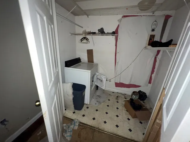 a view of a storage and utility room with washer and dryer