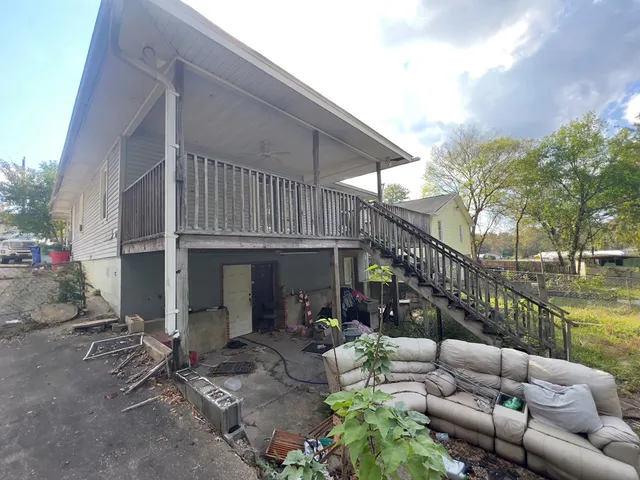 a view of a patio with couches table and chairs and potted plants