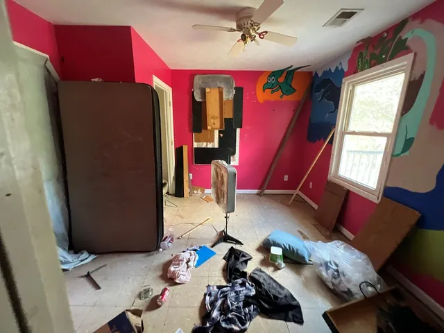 a bedroom with furniture and a window