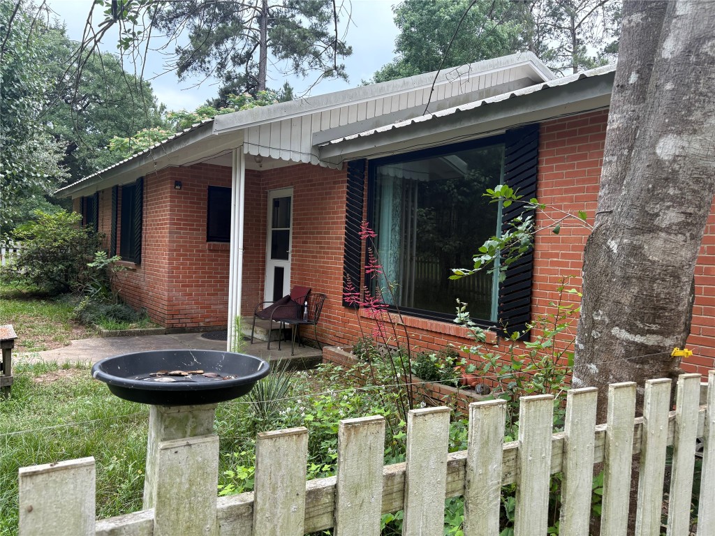 a view of a chair and table in backyard of the house