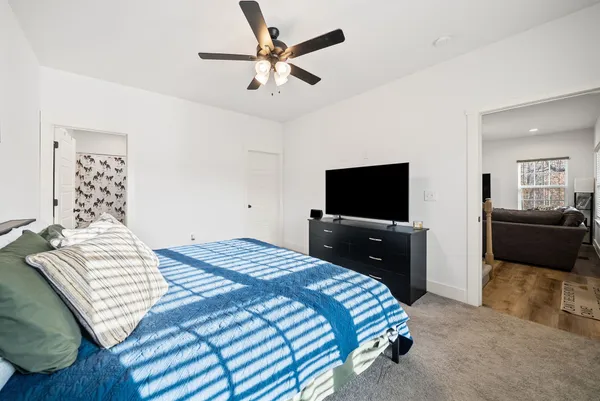 a bedroom with a bed and a flat screen tv