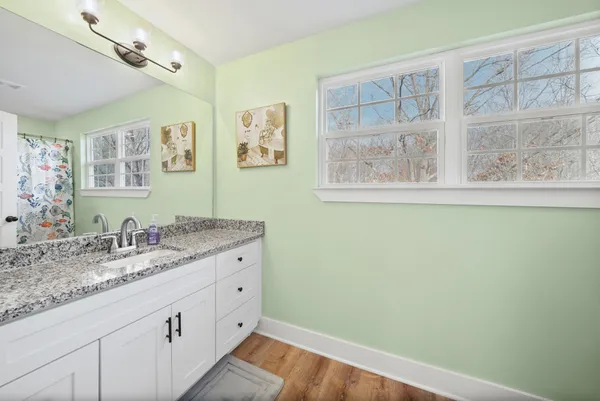 a bathroom with a toilet and a shower curtain