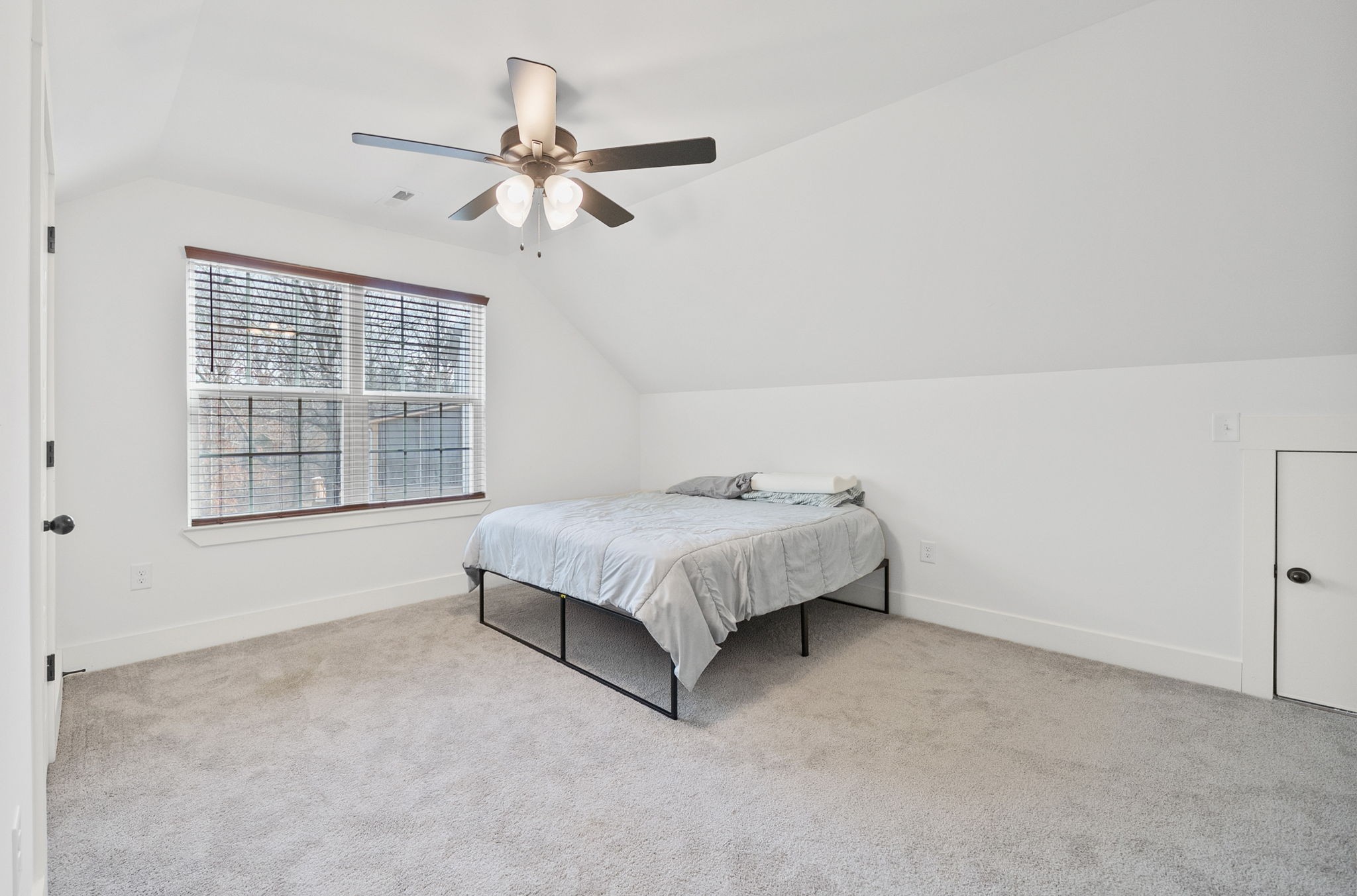 1160 Jonathan Lane Springfield, TN 37172 - Photo 22 of 26 a bed sitting in a room next to a window and a chandelier