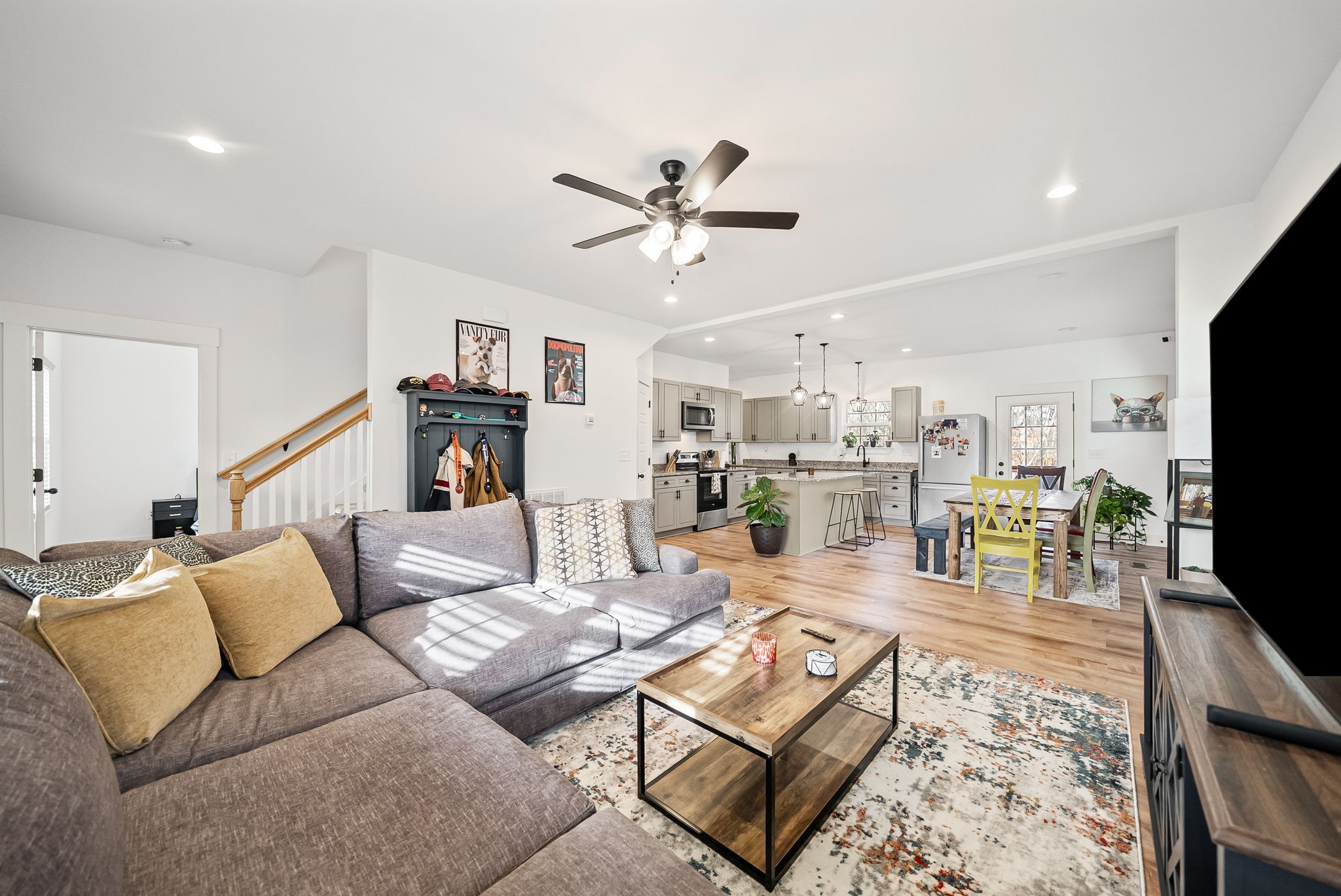 1160 Jonathan Lane Springfield, TN 37172 - Photo 7 of 26 a living room with furniture and a flat screen tv with kitchen view