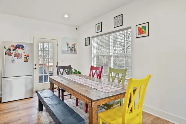 a large kitchen with stainless steel appliances granite countertop a lot of counter space and wooden floor