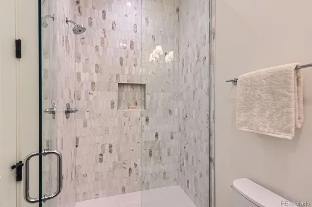 a bedroom with a large bed and a potted plant