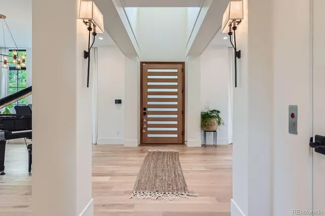 a view of a hallway with wooden floor and staircase