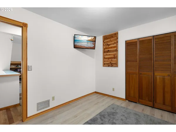 a living room with furniture a rug and a book shelf
