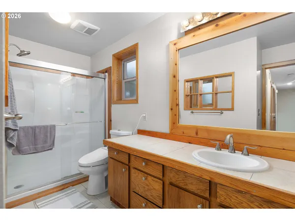 a bathroom with a sink a toilet and a mirror