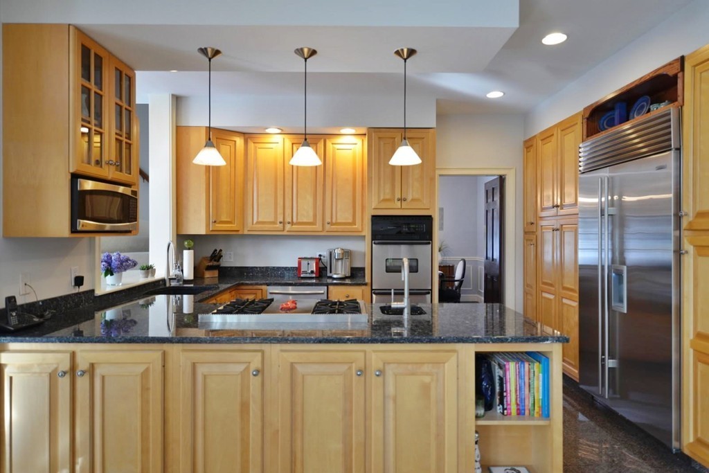 73 Longfellow Road Wellesley, MA 02481 - Photo 3 of 11 a kitchen with stainless steel appliances a refrigerator a sink a stove and cabinets