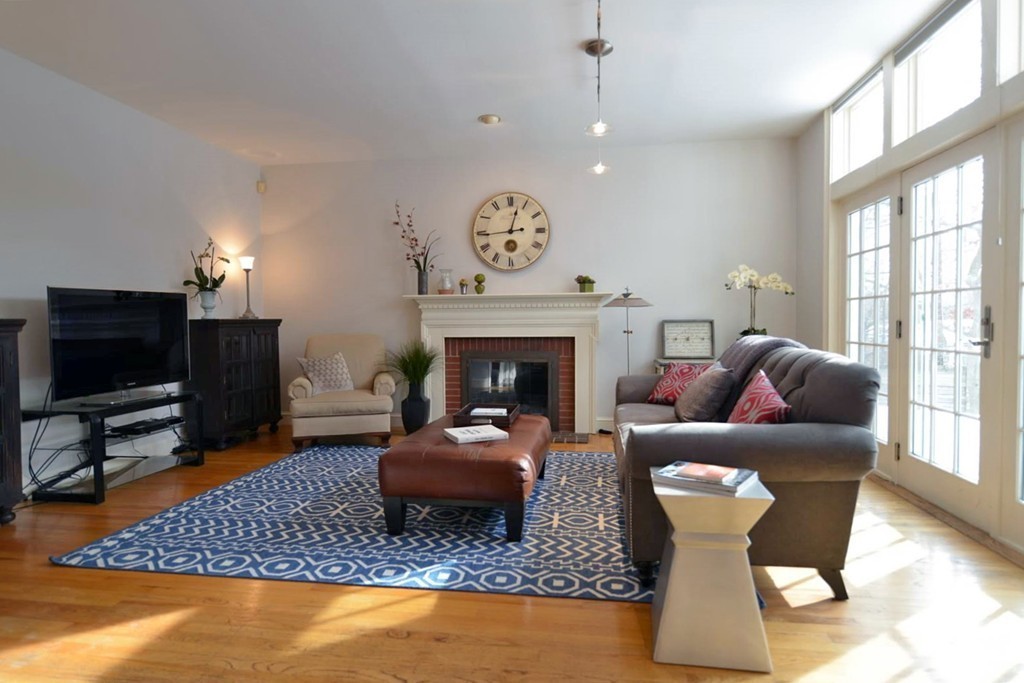 73 Longfellow Road Wellesley, MA 02481 - Photo 4 of 11 a living room with furniture a fireplace and a flat screen tv