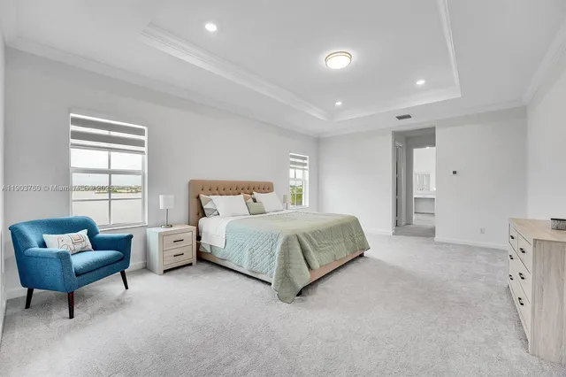 a spacious bedroom with a bed and a couch