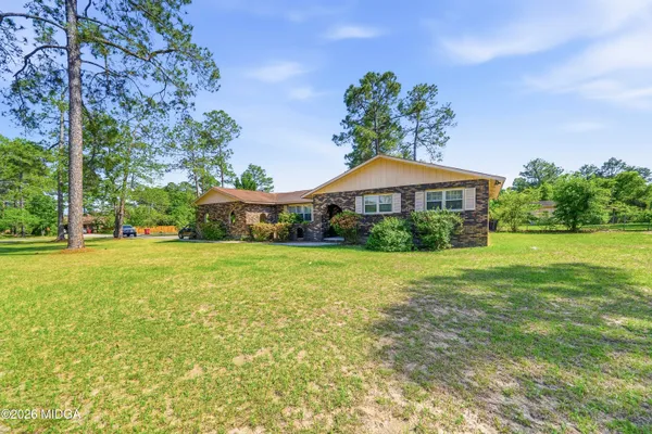 a front view of a house with garden