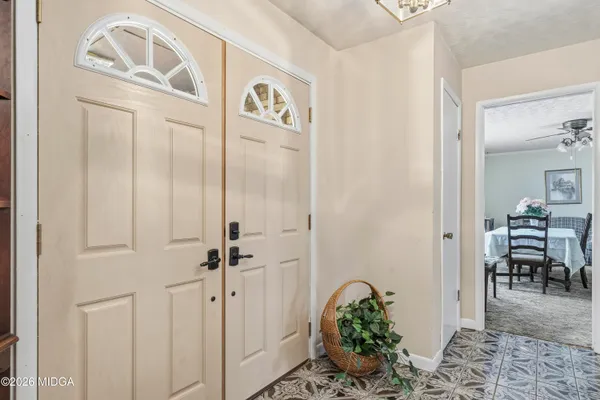 a view of a hallway with dining area