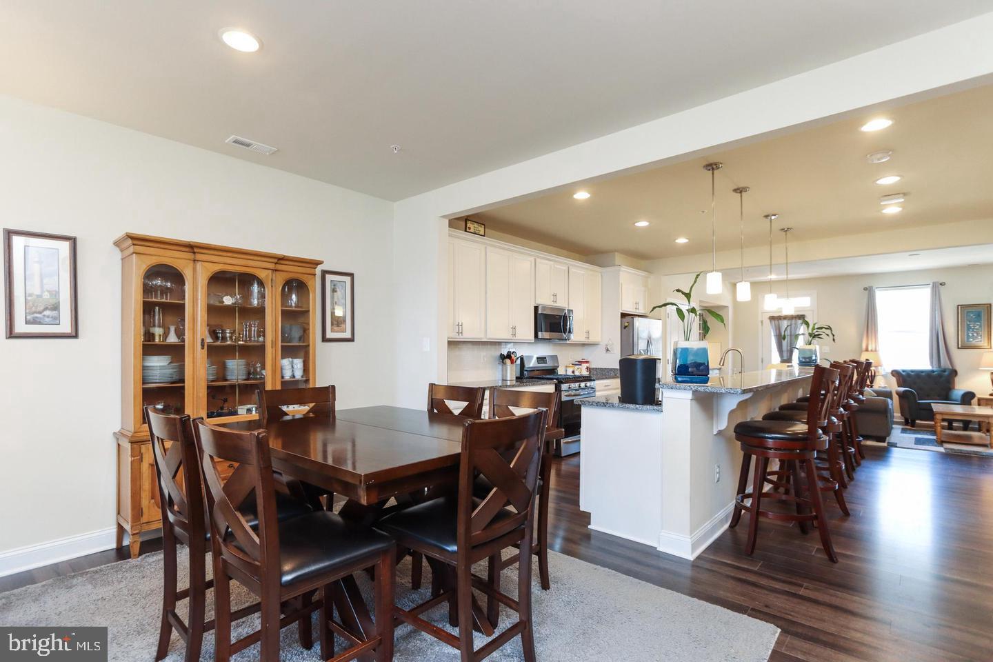 7146 Proclamation Place Frederick, MD 21703 - Photo 11 of 26 a view of a dining room with furniture and wooden floor