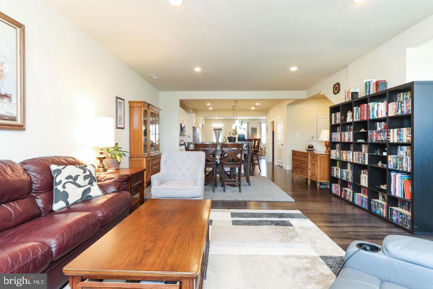 7146 Proclamation Place Frederick, MD 21703 - Photo 12 of 26 a living room with lots of furniture and a book shelf