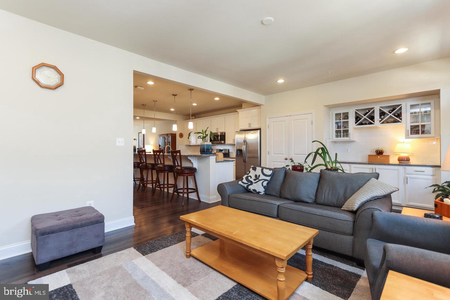 7146 Proclamation Place Frederick, MD 21703 - Photo 15 of 26 a living room with furniture and kitchen view