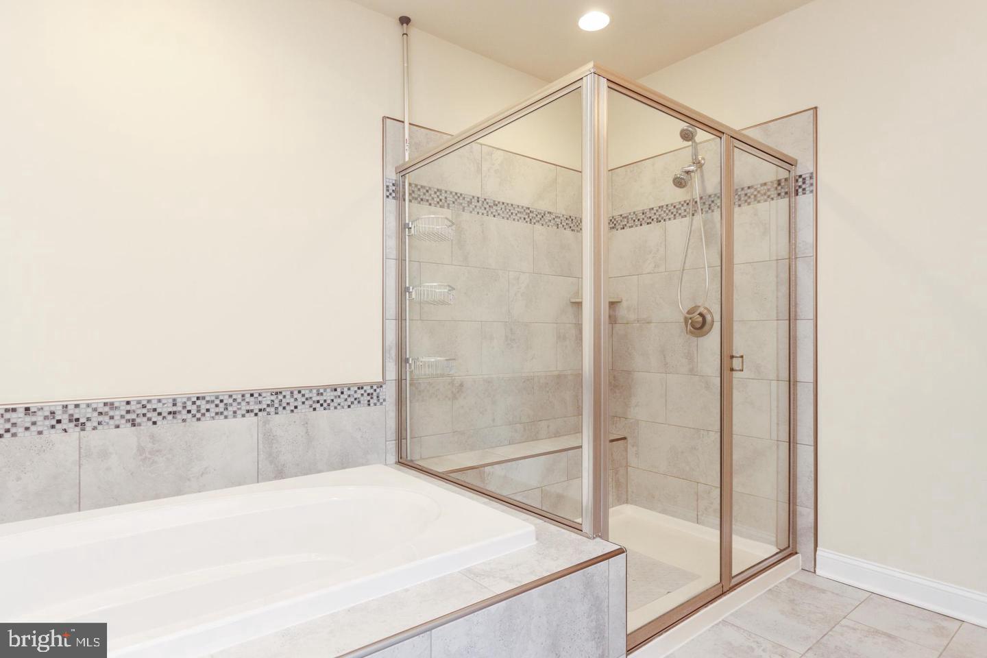 7146 Proclamation Place Frederick, MD 21703 - Photo 21 of 26 a bathroom with a shower and a bath tub