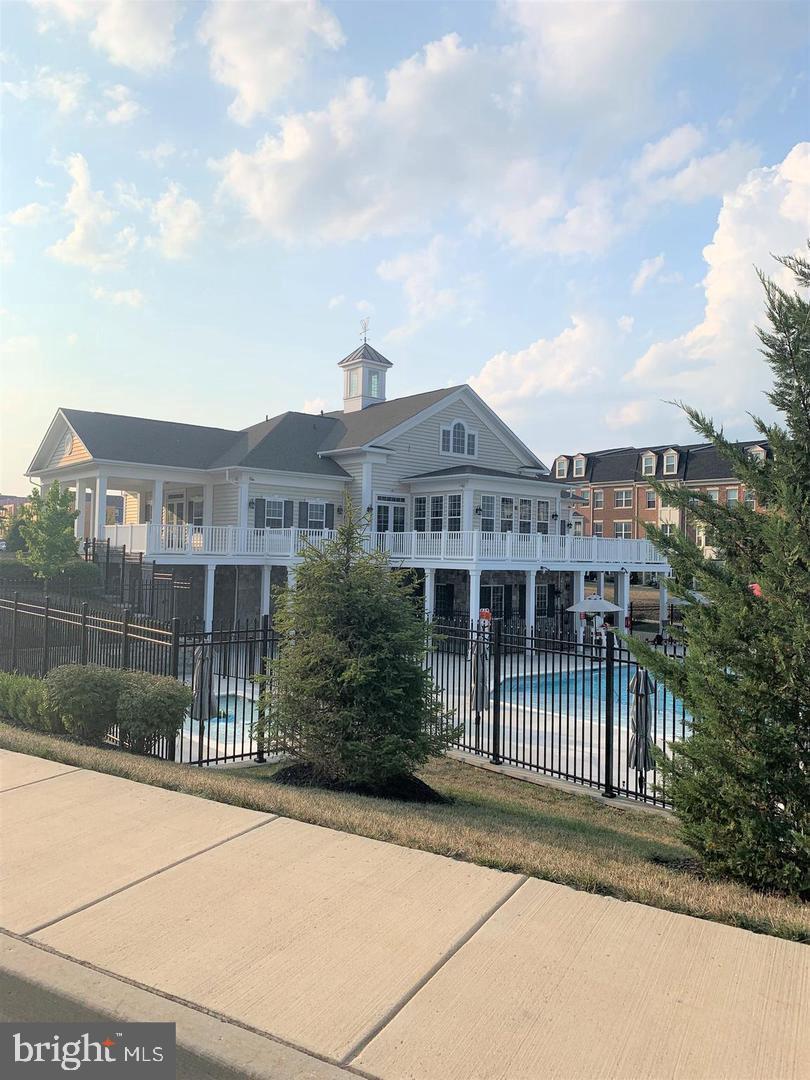 7146 Proclamation Place Frederick, MD 21703 - Photo 25 of 26 a front view of a house with a garden