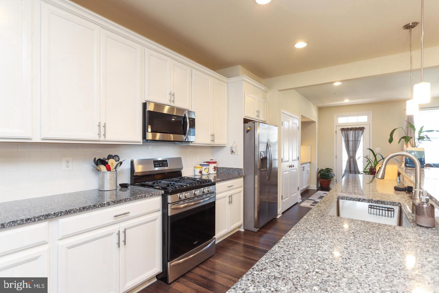 7146 Proclamation Place Frederick, MD 21703 - Photo 8 of 26 a kitchen with stainless steel appliances granite countertop a stove a sink and a refrigerator