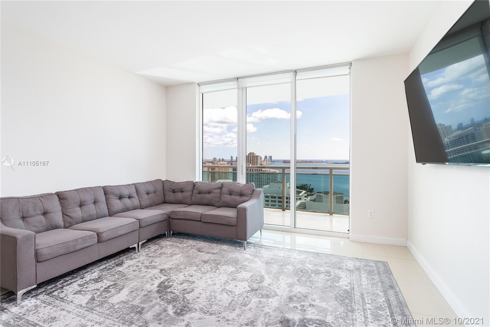 951 Brickell Avenue, Unit 2706 Miami, FL 33131 - Photo 14 of 35 a living room with furniture and a flat screen tv