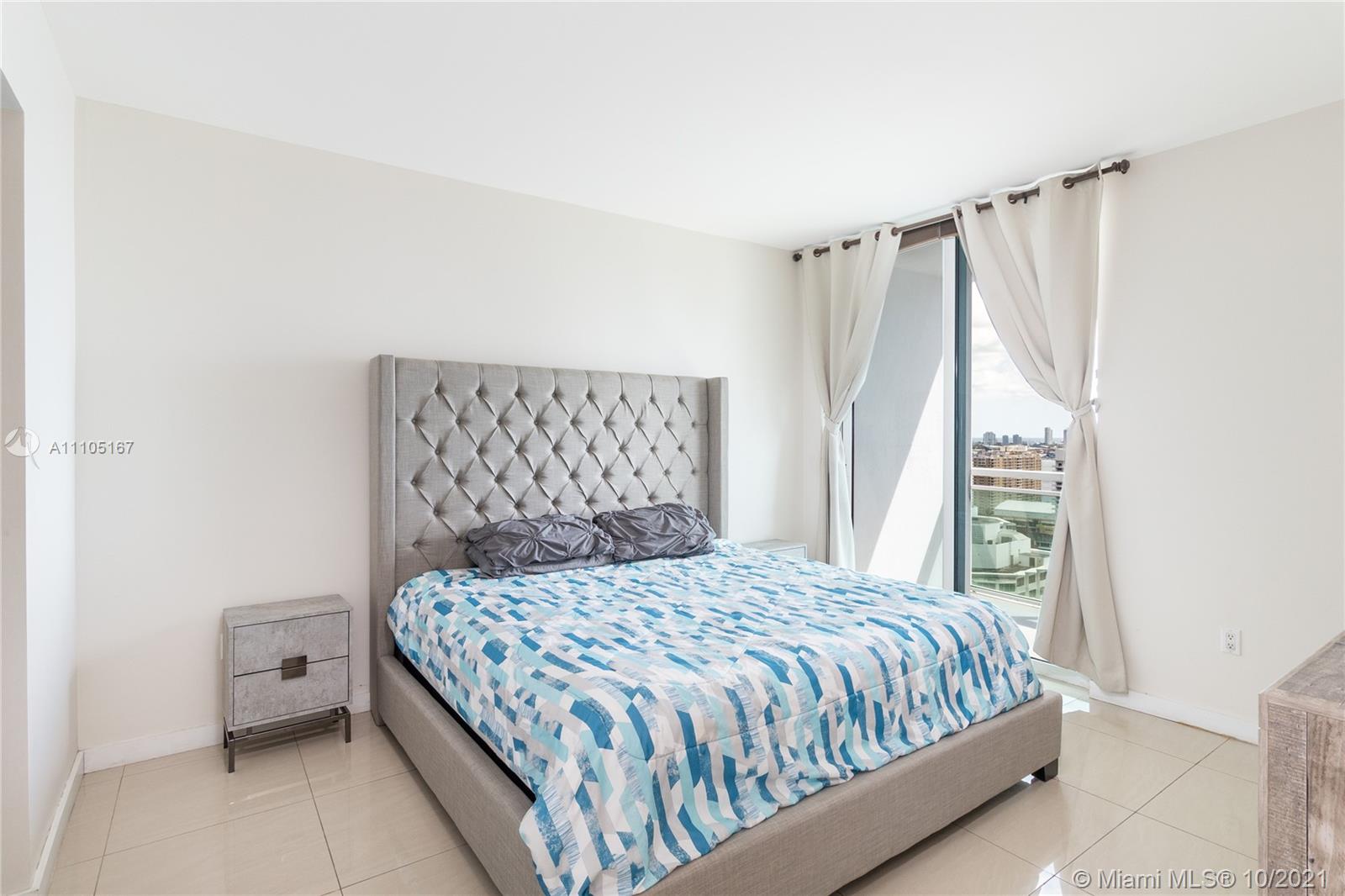 951 Brickell Avenue, Unit 2706 Miami, FL 33131 - Photo 15 of 35 a bedroom with a bed and a window