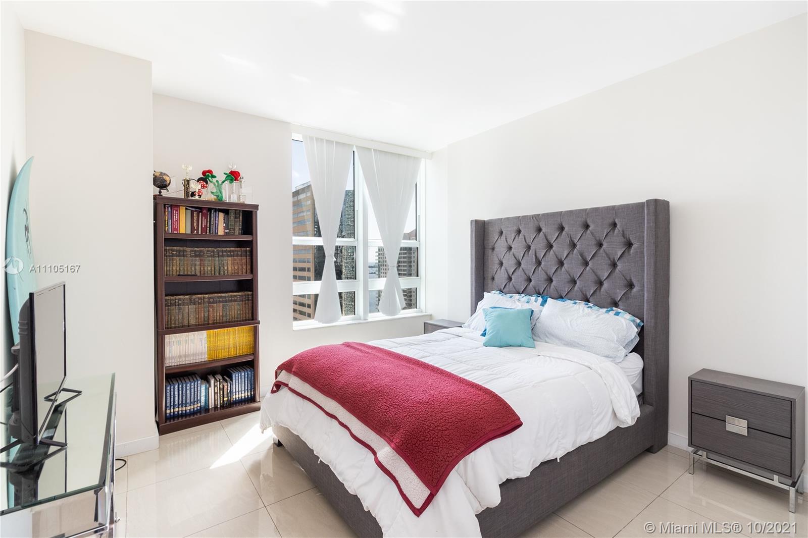 951 Brickell Avenue, Unit 2706 Miami, FL 33131 - Photo 19 of 35 a bedroom with a bed and a large window