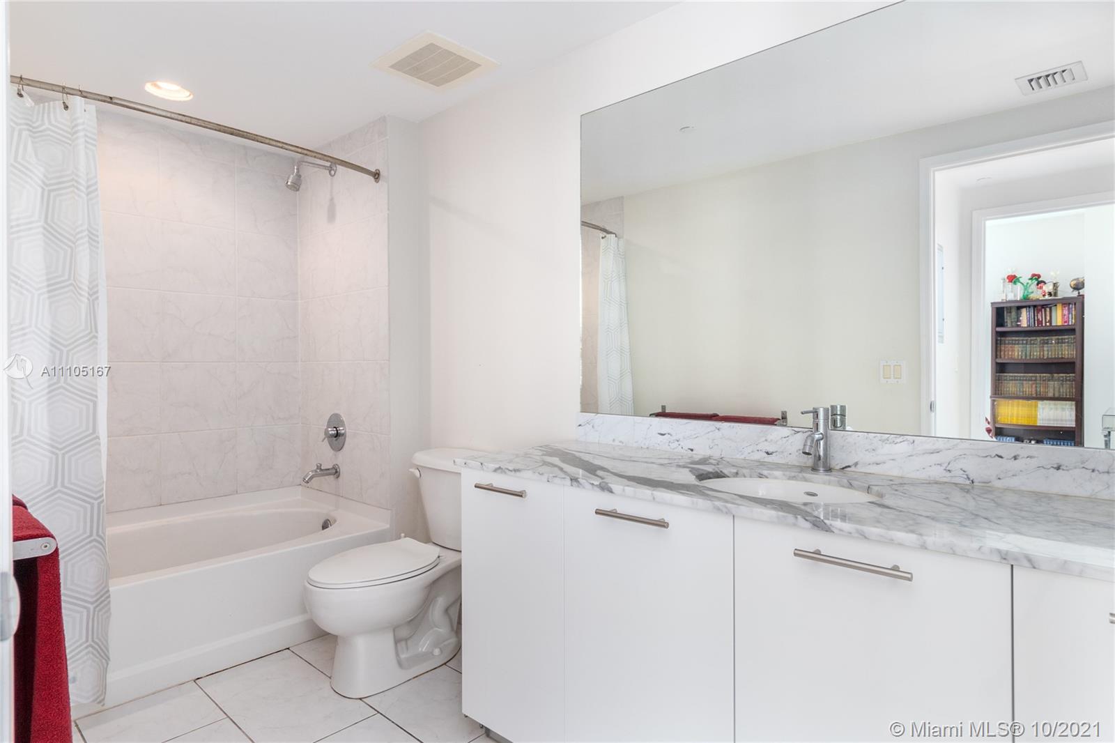 951 Brickell Avenue, Unit 2706 Miami, FL 33131 - Photo 21 of 35 a bathroom with a granite countertop sink toilet and shower