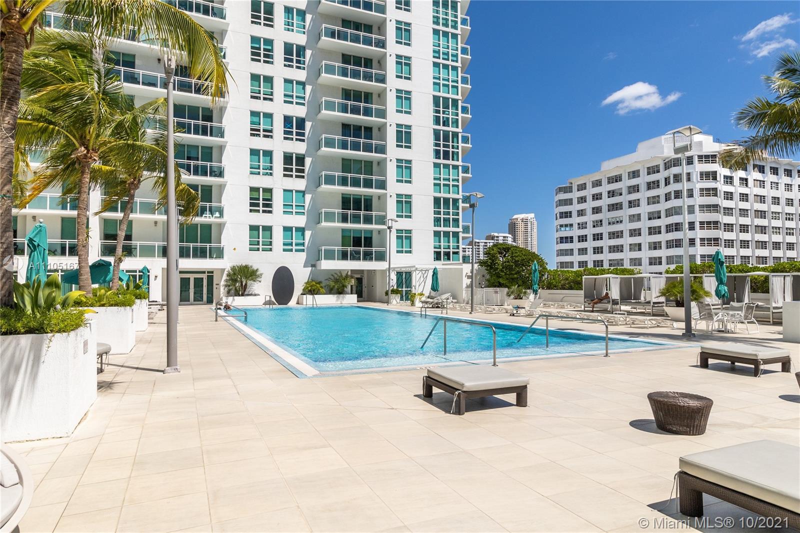 951 Brickell Avenue, Unit 2706 Miami, FL 33131 - Photo 24 of 35 a swimming pool with outdoor seating and yard