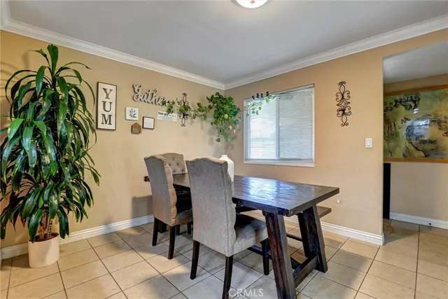 a living room with kitchen island furniture and a potted plant
