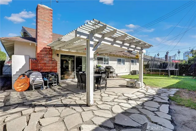 a view of a house with backyard porch and sitting area