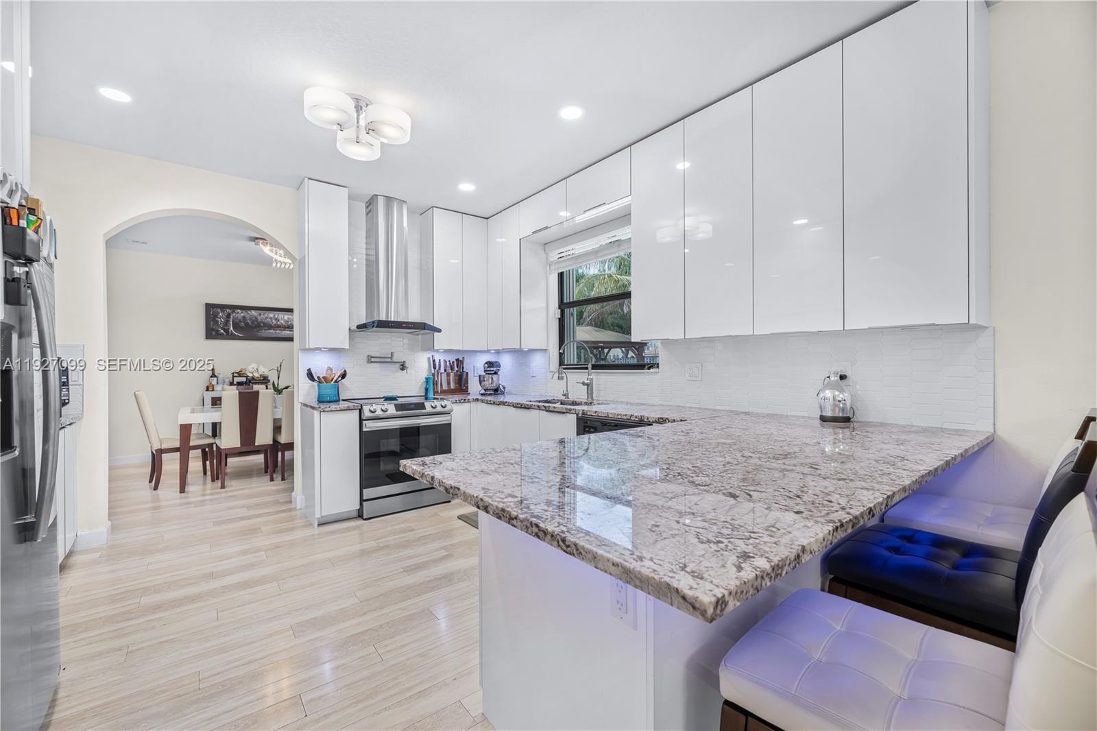 3461 Southeast 1st Street Homestead, FL 33033 - Photo 13 of 58 a kitchen with granite countertop a sink a counter top space appliances and cabinets