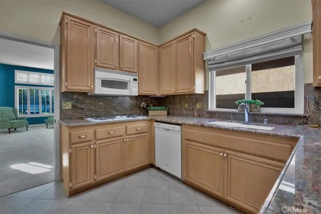 a kitchen with cabinets appliances and a sink