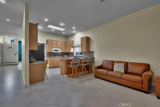 a living room with furniture and kitchen view