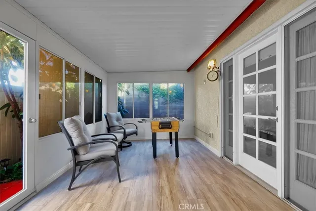 a balcony with chairs and wooden floor