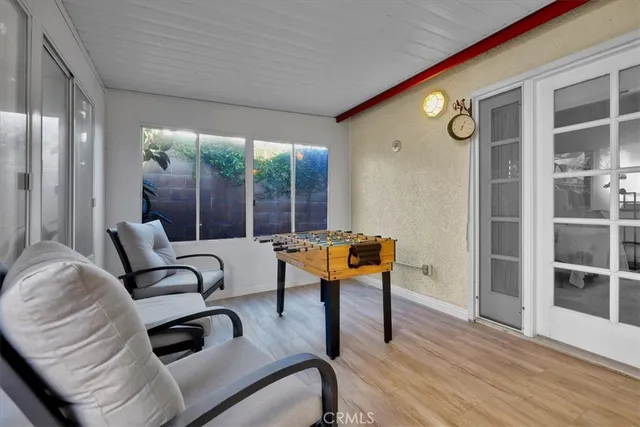 a living room with furniture a table and wooden floor