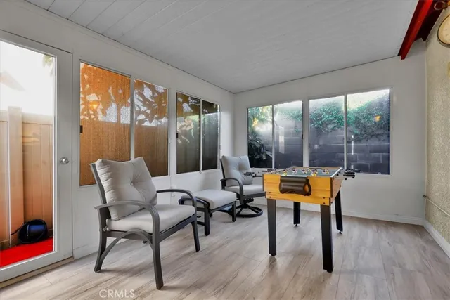 a living room with furniture and a floor to ceiling window