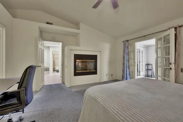 a bedroom with a bed mirror and a desk