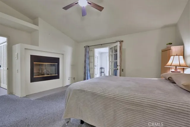 a bedroom with a bed and a painting on the wall