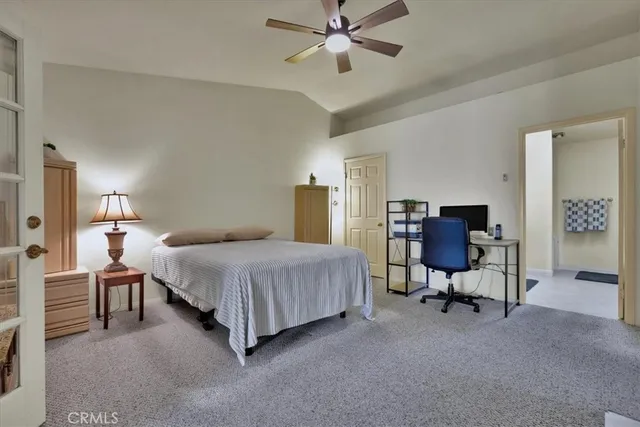 a bedroom with a bed chair and a chandelier