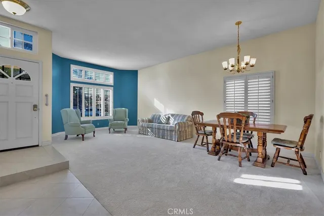 a living room with furniture windows and a chandelier
