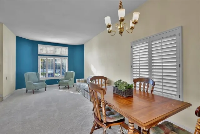 a view of a dining room with furniture and window