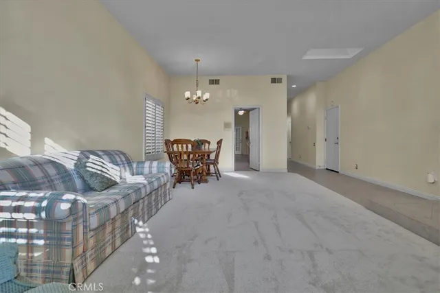 a view of a livingroom with furniture and chandelier