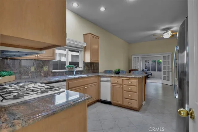 a kitchen with stainless steel appliances granite countertop a stove and a sink