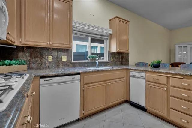 a kitchen with cabinets appliances a sink and a counter top space