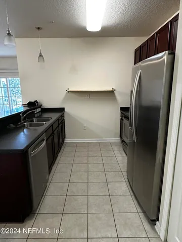 a kitchen with a black white cabinets and a stove top oven