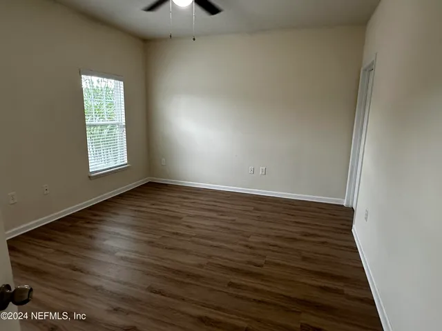 wooden floor in an empty room with a window