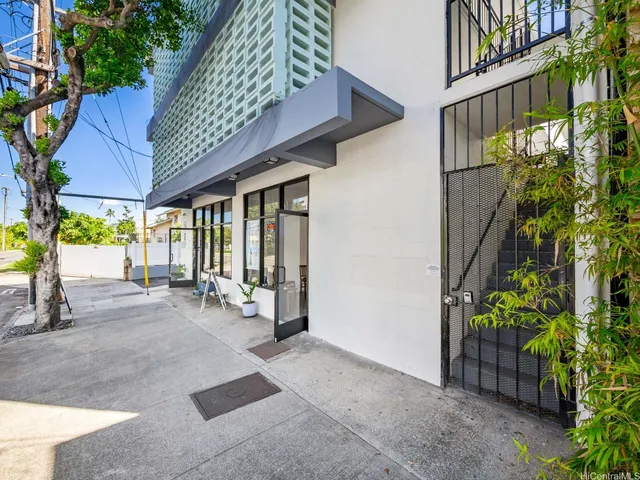 a living room with furniture a flat screen tv and a floor to ceiling window