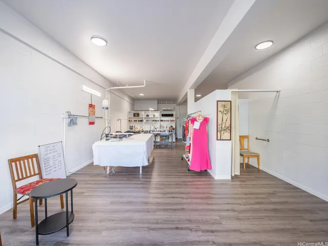 a large white kitchen with a table and chairs in it